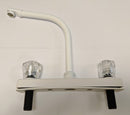 A white hi-rise kitchen faucet with clear knob handles and plastic stems, against a plain background.