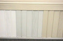 A stack of white pre-cut vented skirting panels displayed on a mobile home.
