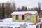 mobile home in the wintertime with snow and trees in the background star mobile home supply